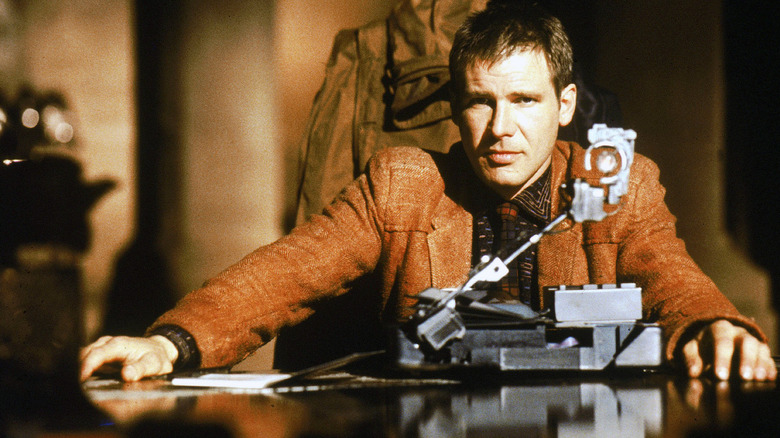 Rick Deckard sitting at a table in Blade Runner