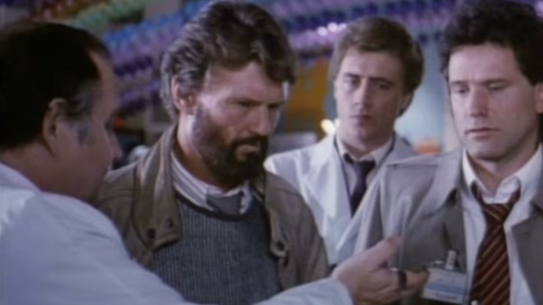 Bill Smith (Kris Kristofferson) surrounded by scientists in "Millennium."