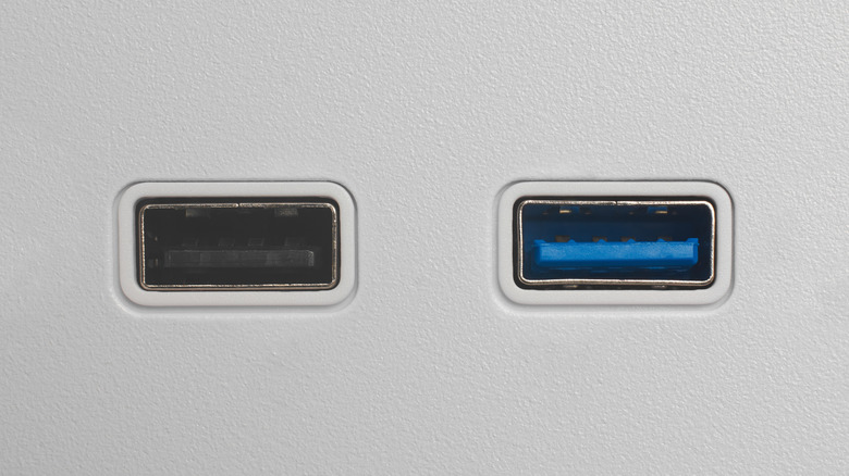 black and a blue USB port on a device next to each other