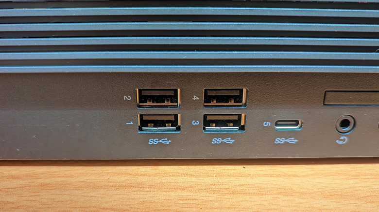 USB ports on back of a device showing SuperSpeed logo below some of them.