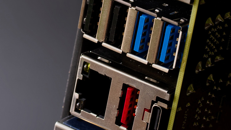 Close up of a motherboard back panel connectors on a dark background