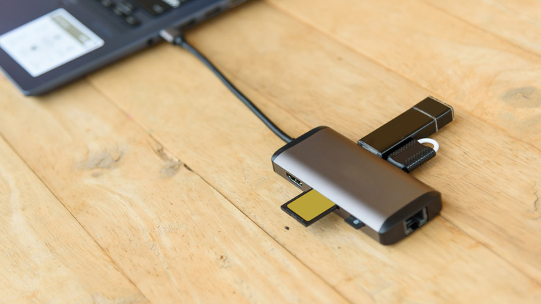 USB hub plugged into a laptop port with other devices plugged into it
