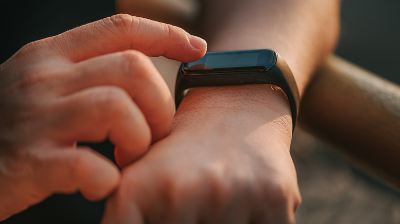 a close up of a person checking a fitness tracker