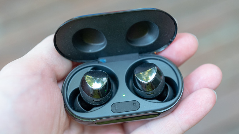 Closeup of a man holding the Bluetooth Samsung Galaxy earbuds