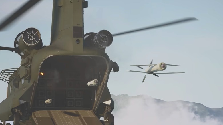 Still from a CGI video of drones launching out of a CH-47F Block II Chinook helicopter
