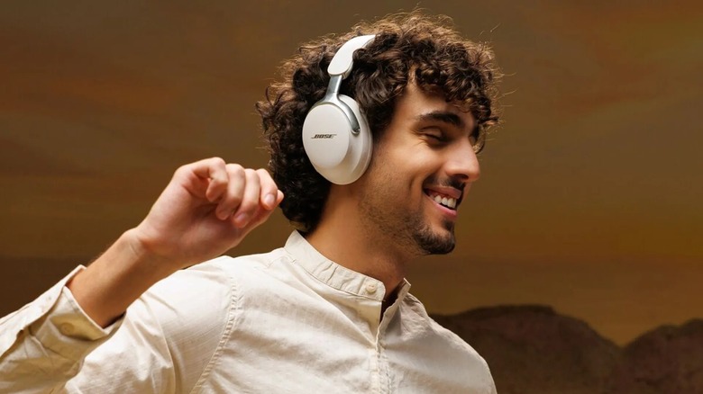 Man wearing Bose QuietComfort Ultra 2nd Gen while smiling