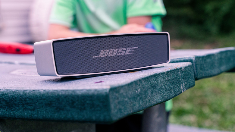 A Bose speaker sitting outside on a table
