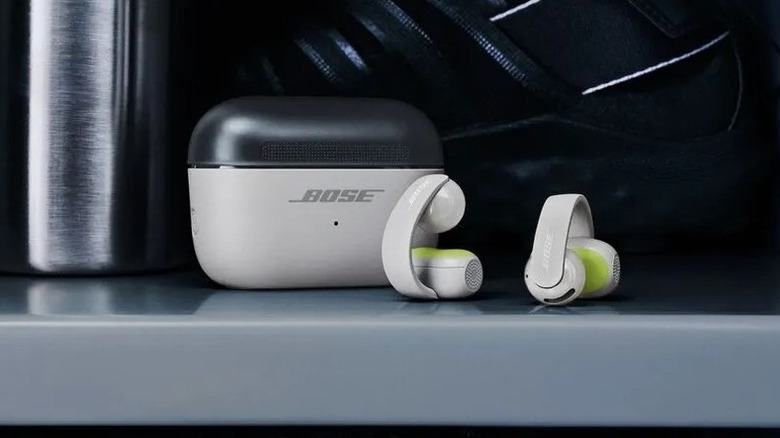 Bose Sport Open Earbuds with their case in a locker