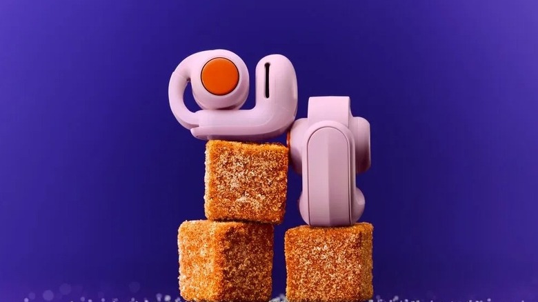 Bose Ultra Open Earbuds (2nd Gen) in pink over pieces of sweets