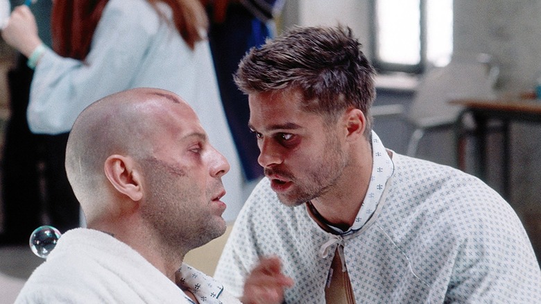 Bruce Willis and Brad Pitt staring at each other in 12 Monkeys
