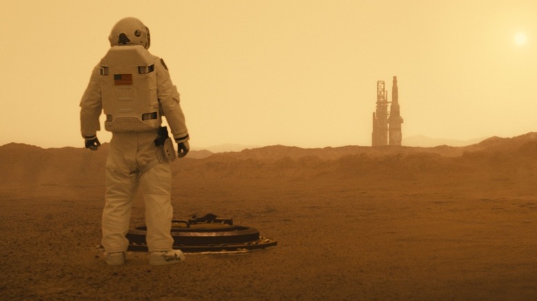 Roy (Brad Pitt) looking at a rocket in "Ad Astra."