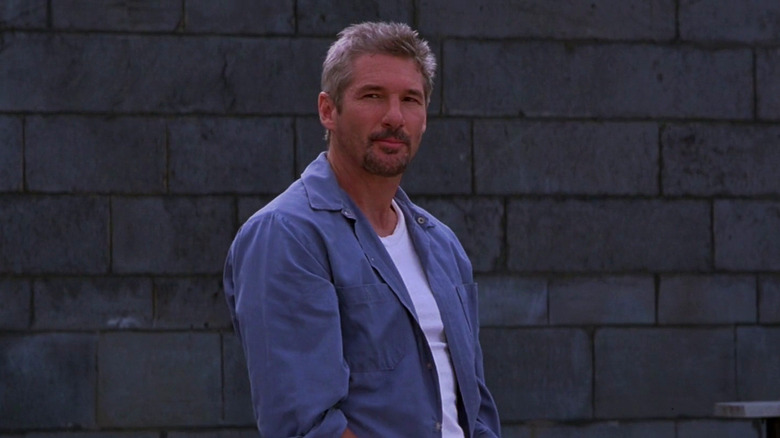 Declan Mulqueen in the prison yard, looking somberly