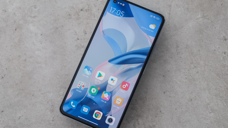 Xiaomi budget Android smartphone on the counter with screen on.