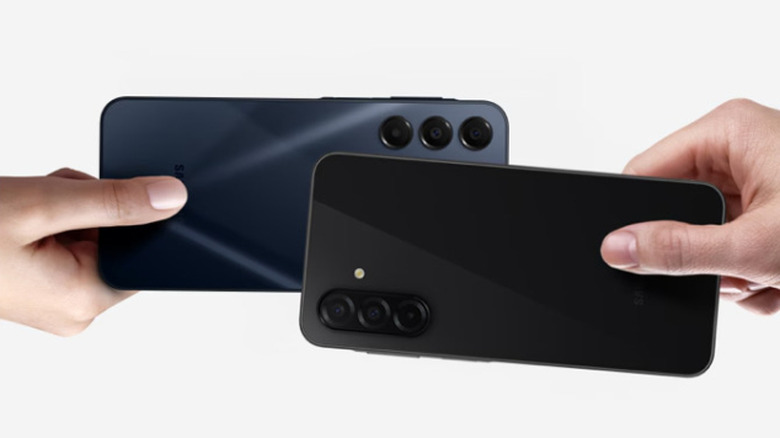 Two people holding Samsung Galaxy A26 5G phones