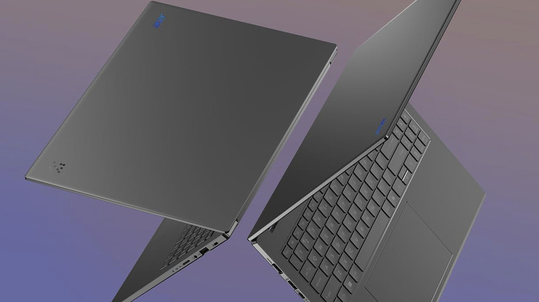A product render featuring two gray Acer Aspire 16 AI laptops floating in front of a purple background.