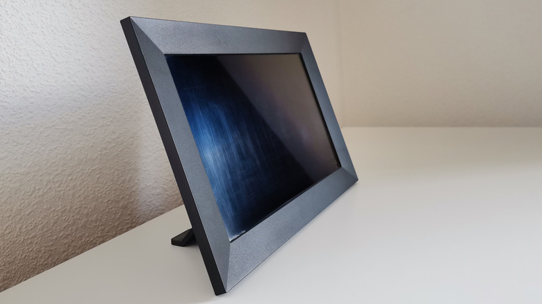 Close up of a digital photo frame with a black color and the screen off.