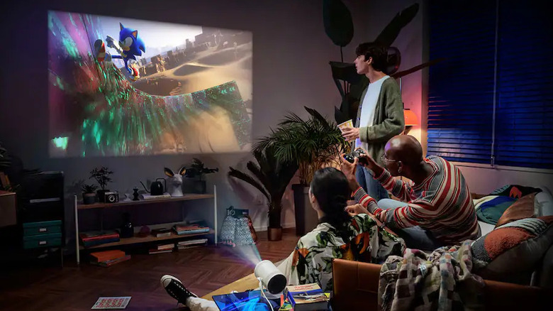 People playing video games on the Samsung The Freestyle Gen 2 projector.