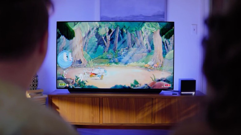 Steam Machine visible in living room and connected to TV with couch play.