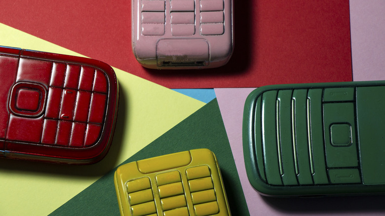 The bottom of mobile flip phones in various colors.