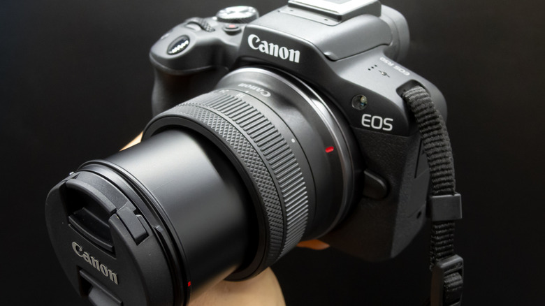 Canon EOS R50 mirrorless camera with a kit zoom lens shown in close-up.
