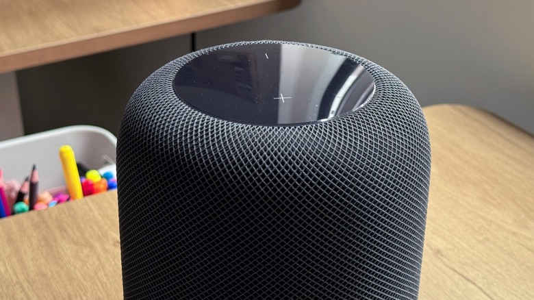 A HomePod on a wooden table