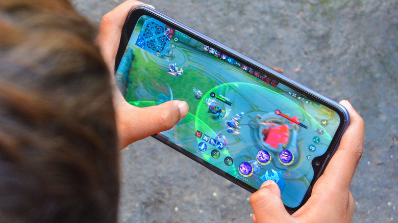 A person playing a game on a smartphone.