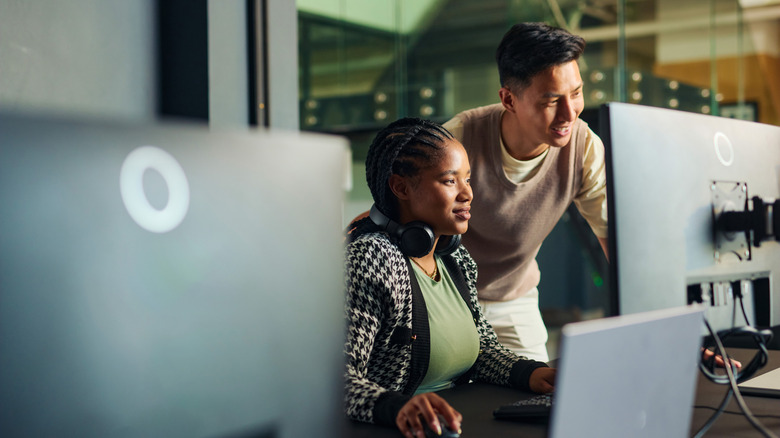 Computer tech support engineers working on a PC