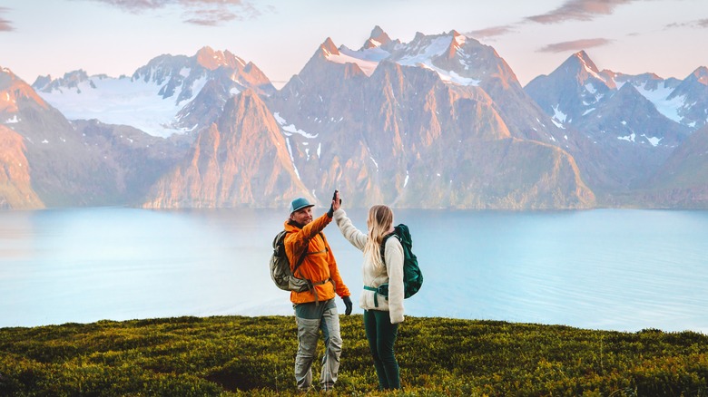 Man and woman high-fiving during hiking trip