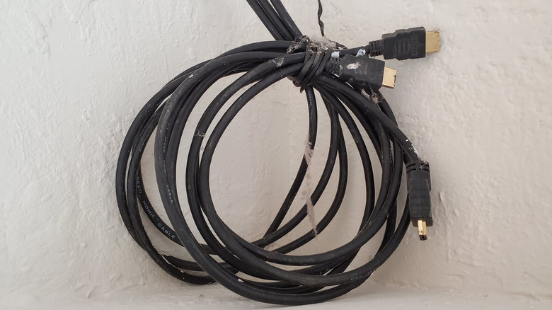 A bunch of HDMI cords wrapped together next to a wall