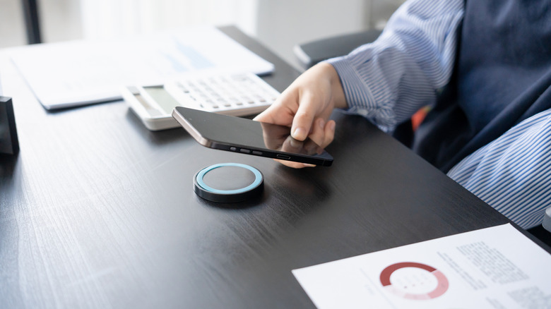 Artwork of a woman with a laptop sitting atop a magnet.