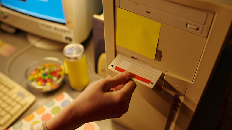 A girl on the floor watching cartoons on a CRT TV.