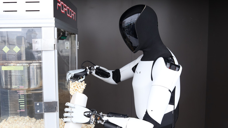 A Optimus Humanoid Robot Serves Popcorn to Patrons at The First Ever TESLA DINER on Opening Day.