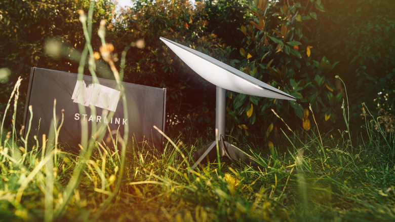Starlink satellite receiver in the grass and connected for remote internet.