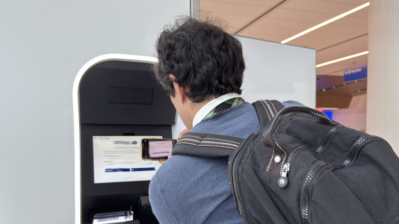 a man scanning a digital ID at a TSA checkpoint