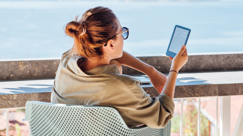 A woman reading a book on an e-reader