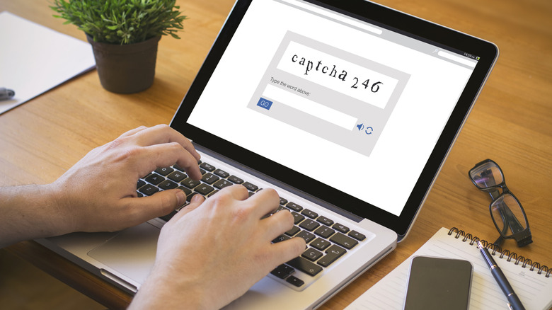 laptop user solving CAPTCHA