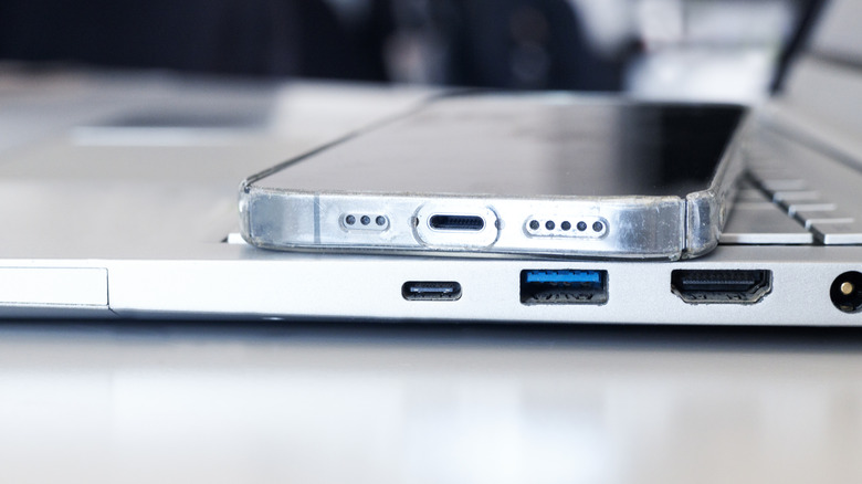 A phone and laptop showing front-view of their USB-C ports