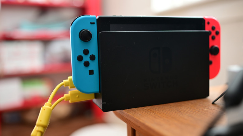 Nintendo Switch console on its dock with two cables attached