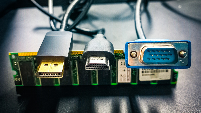HDMI, DisplayPort, and VGA connectors lined up on top of a stick of RAM