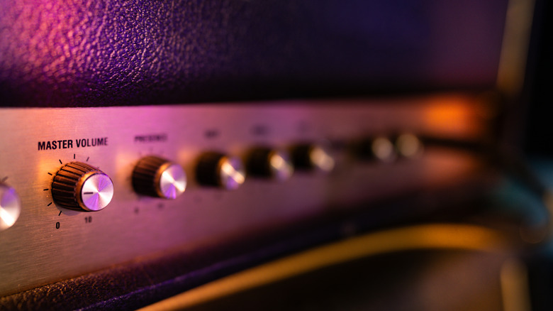 A close-up view of the volume and tone knobs on a guitar amp.