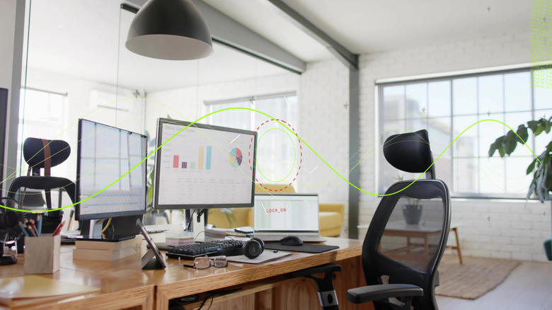 Two monitors connected to a laptop in an office setting.