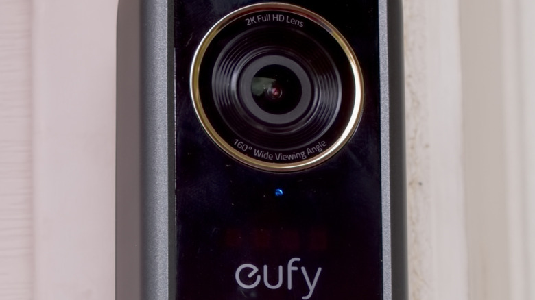 A Nest video doorbell mounted to a brick exterior.