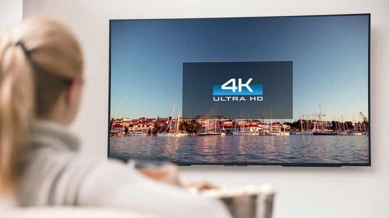 A person watching 4K video on a TV.
