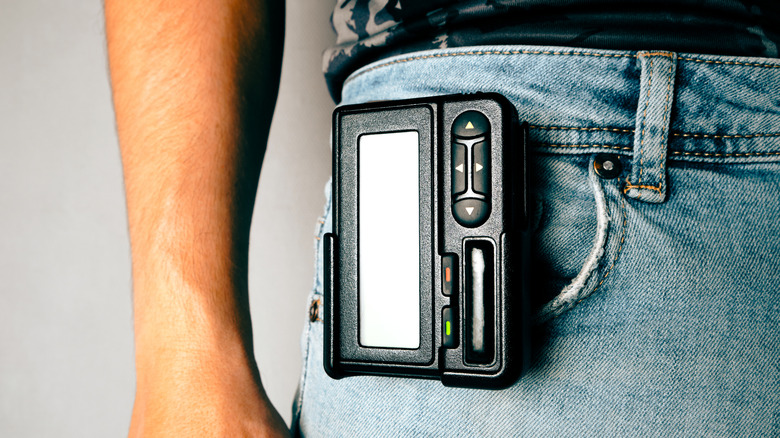 Pager hanging from a person's waistband