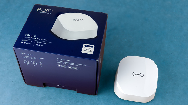 An Amazon eero mesh Wi-Fi router next to its packaging