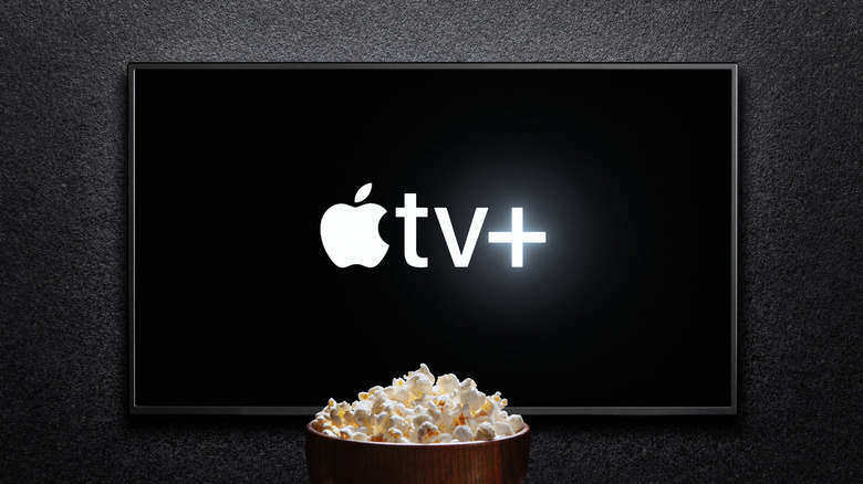apple tv logo on a tv with a bowl of popcorn in the foreground