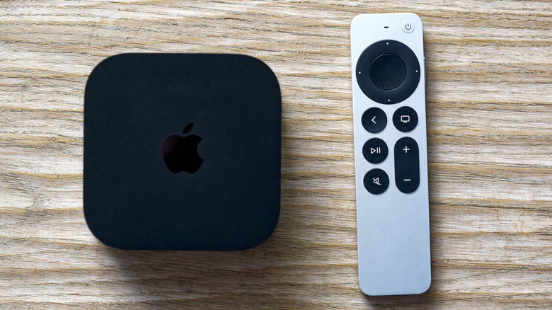 apple tv with remote on a wooden surface