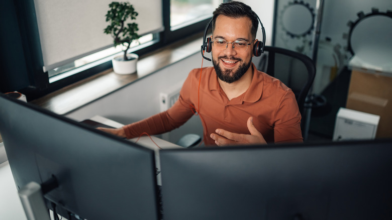 a man working on two monitors