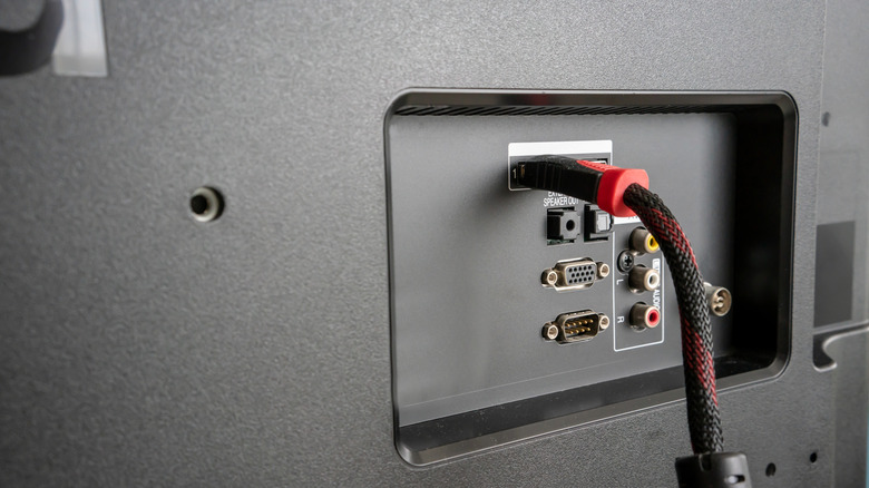 An HDMI cable plugged into the back of a display