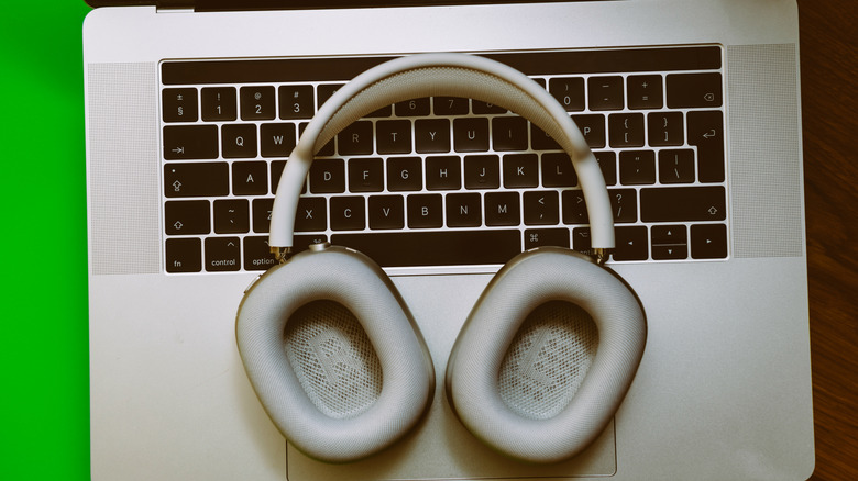 The AirPods Max placed on top of a MacBook.